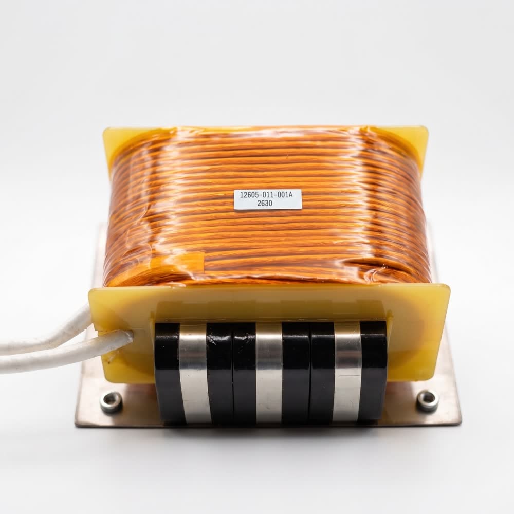 A foil winding on a bobbin over a gapped stacked core