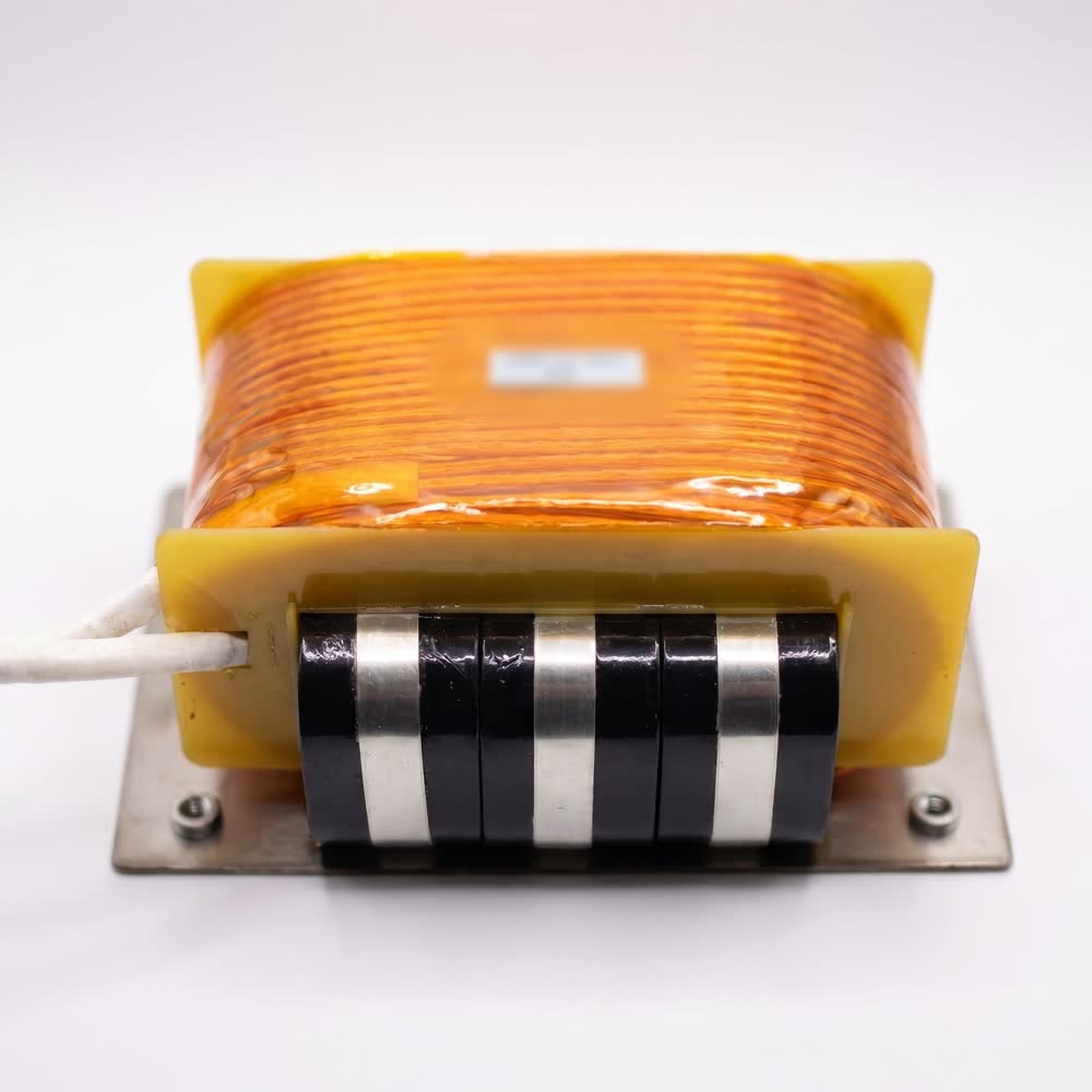 A chassis mounted magnetic with a taped winding over a stacked lamination core